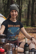 Person wearing a 'Moto Camper' t-shirt in a forest setting with camping gear and wine bottle.